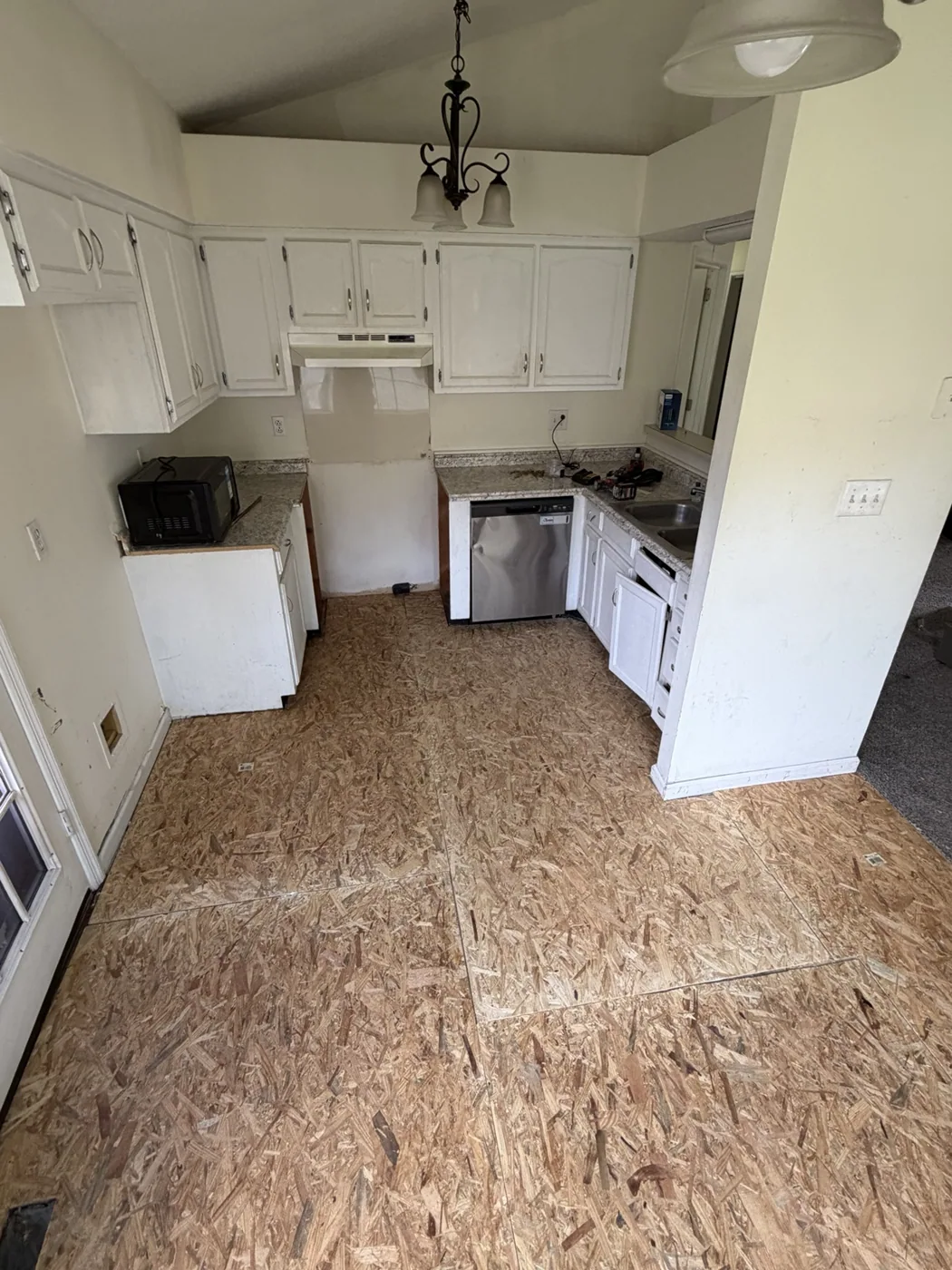 OSB subfloor in kitchen before flooring installation
