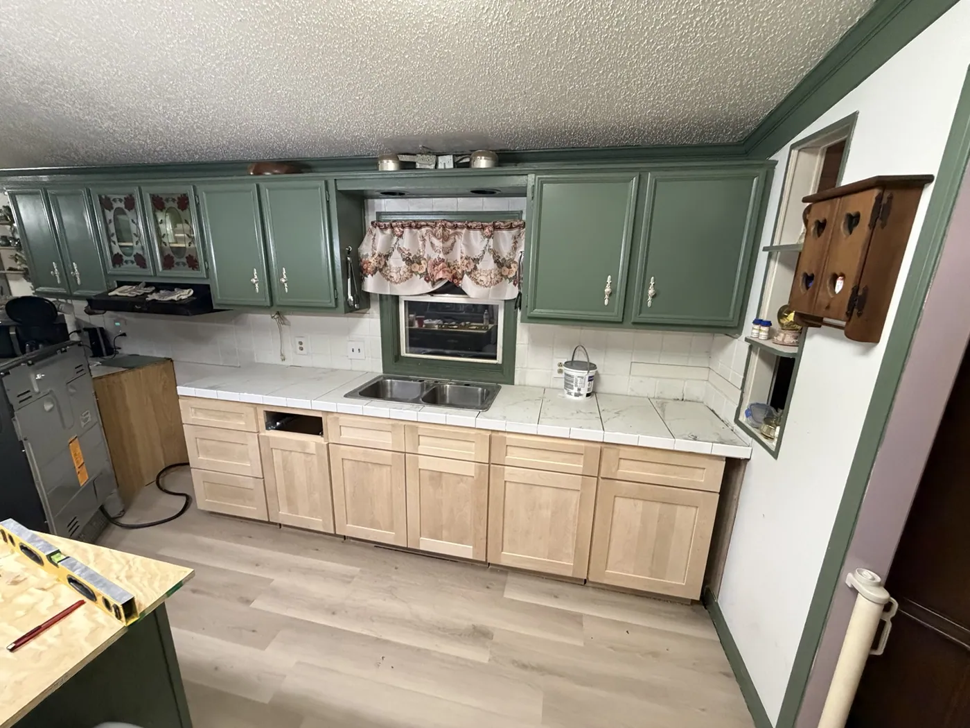 Kitchen cabinets in place during countertop and flooring renovation